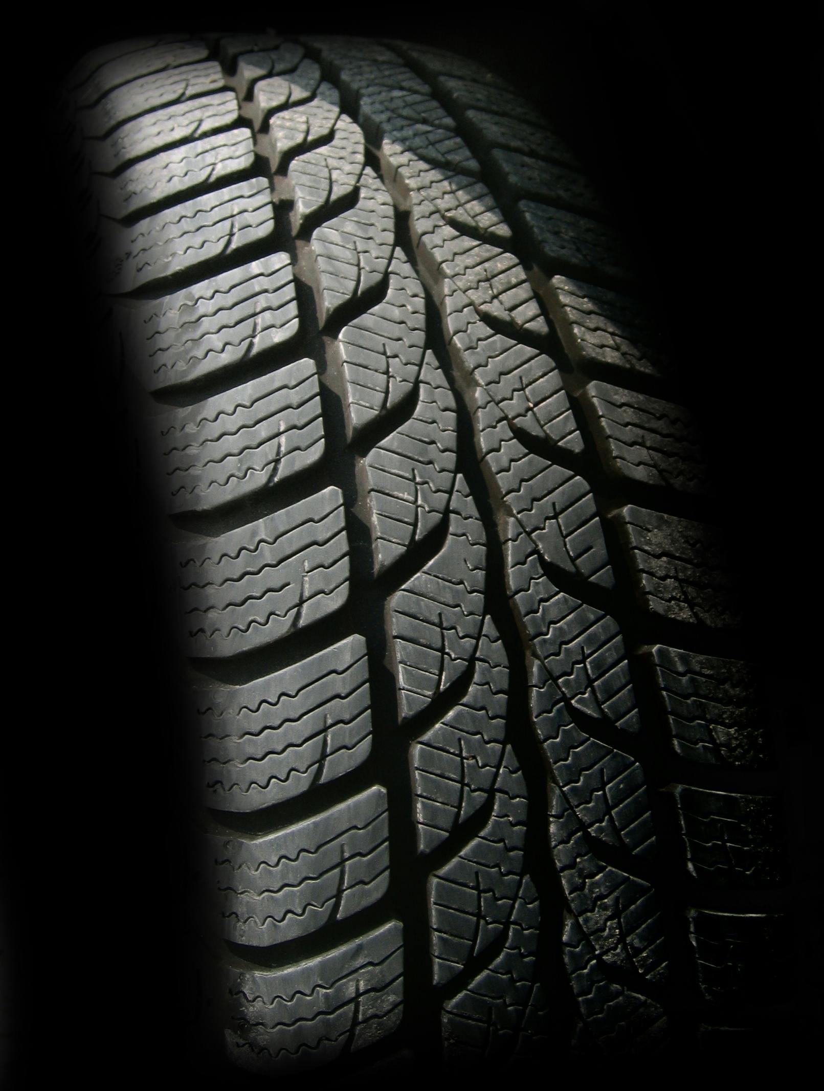 Close-up view of detailed tire tread pattern with strong directional grooves.